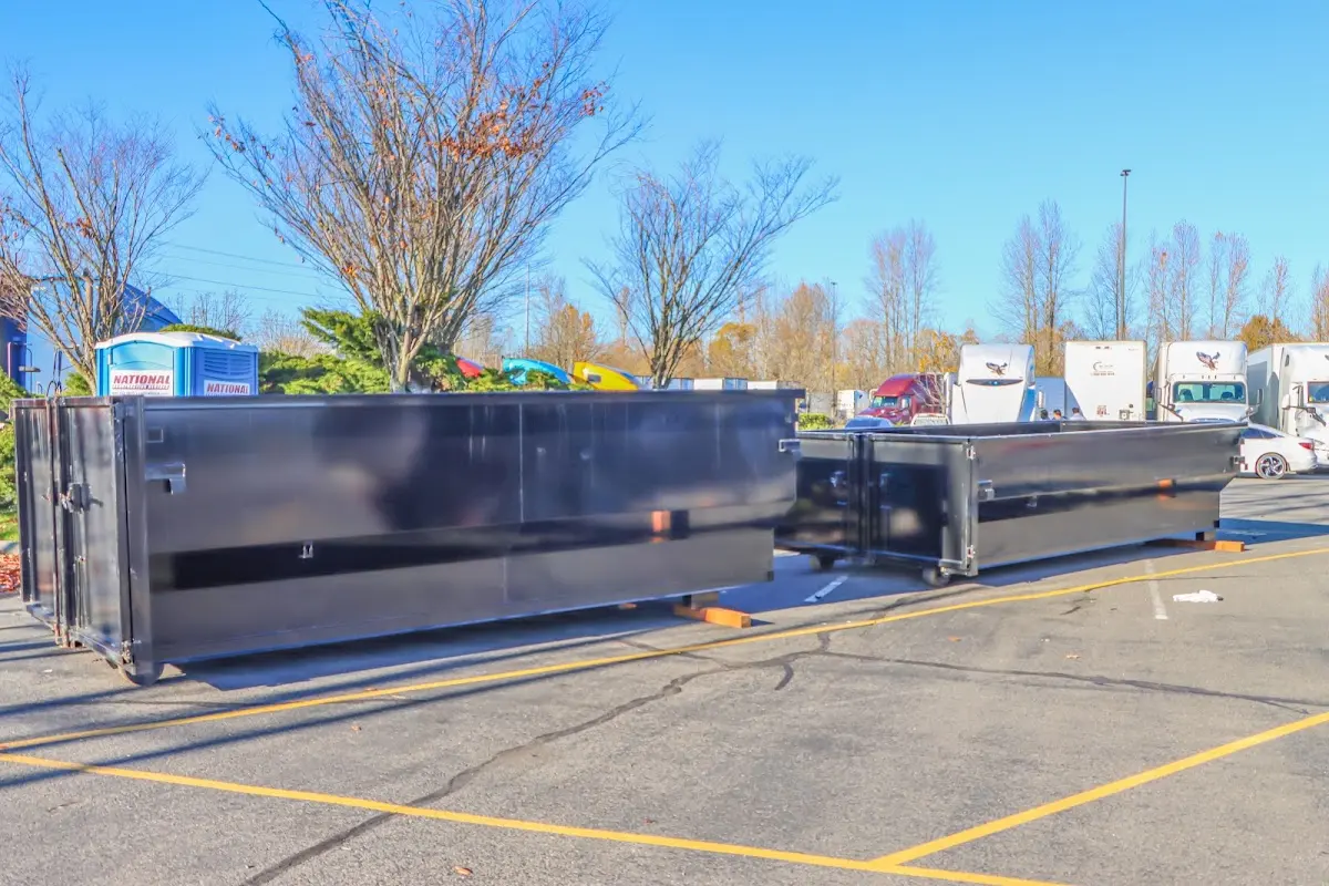 Professional dumpster rental service with roll-off container on residential driveway in Corpus Christi